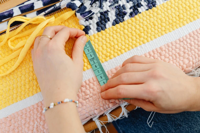 a woman measuring the width of a blanket