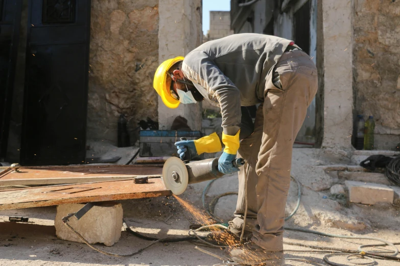 the man is working on a piece of wood