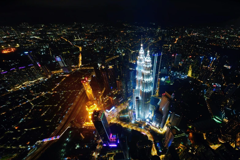 a city lit up with lights and buildings in the night