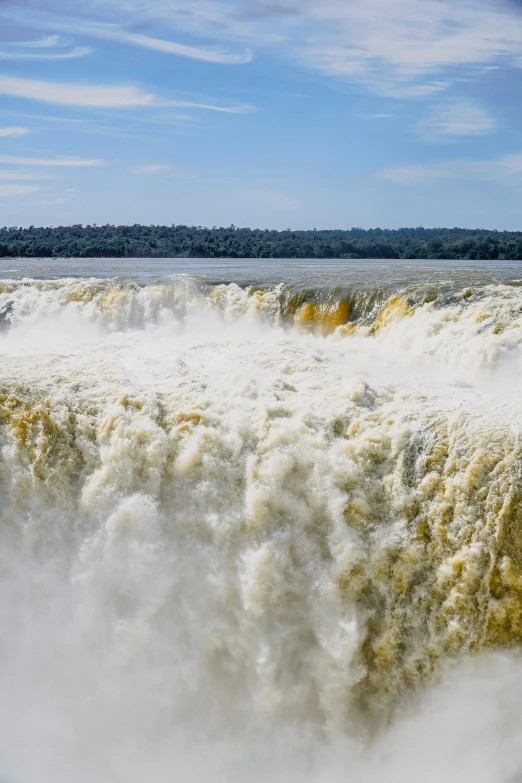 water spilling down a large waterfall into the air