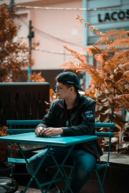 a person sitting at a table with two chairs