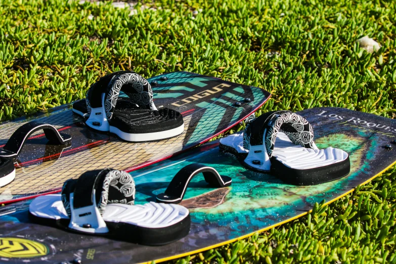 two skate boards sitting in the grass on the ground