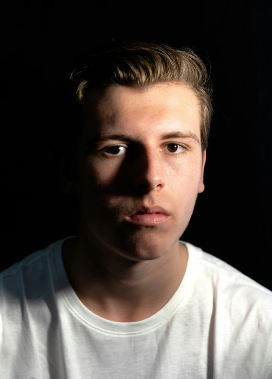 a close up po of the face of a man in a dark background