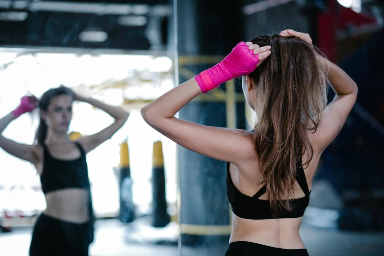 two women in sports wear standing near each other