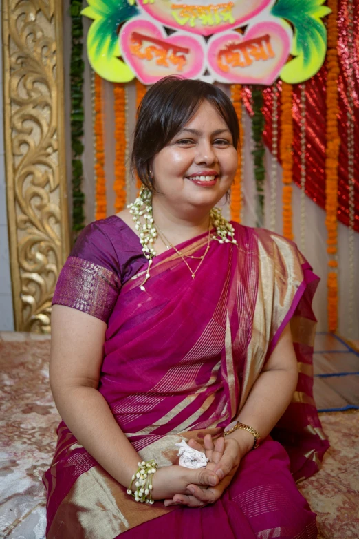 a women that is smiling in a pink dress