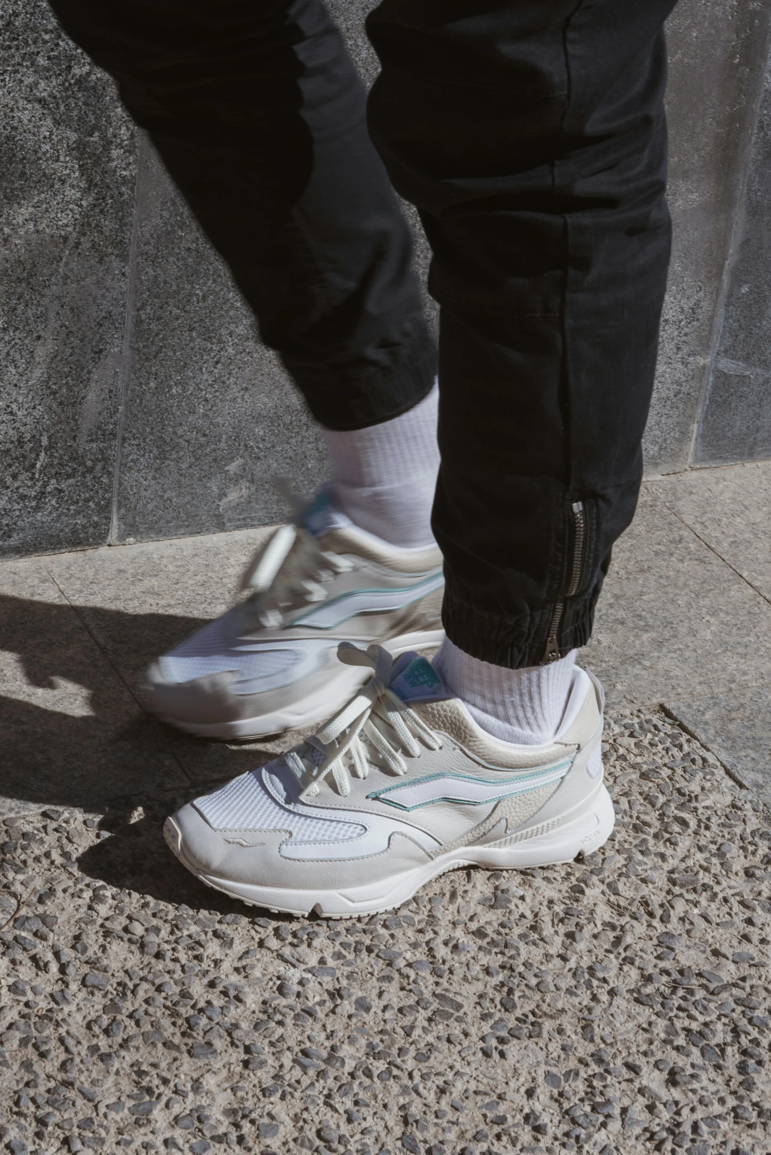 a closeup s of the feet of someone wearing white sneakers