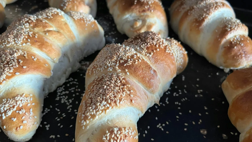 croissants covered in sesame seeds are lined up