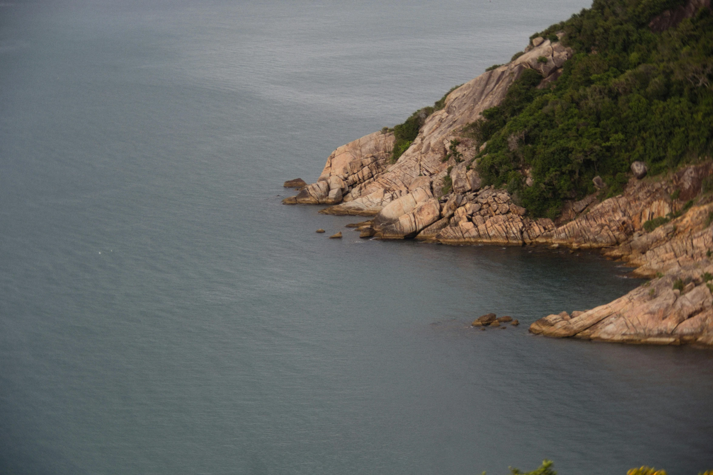 two large rock formations on top of a small body of water