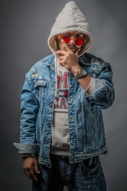 a person is wearing sunglasses and a denim jacket