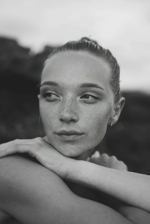 black and white portrait of a woman with shoulder resting on arm