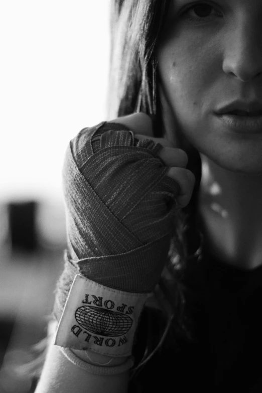 a woman holding on to her arm with an item pinned to it