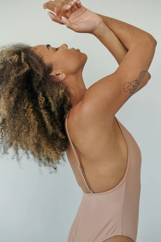 a woman in a pink bathingsuit is holding her head