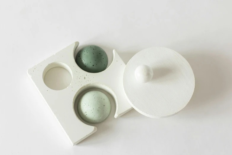 a tray with three saucers and a cupcake mold