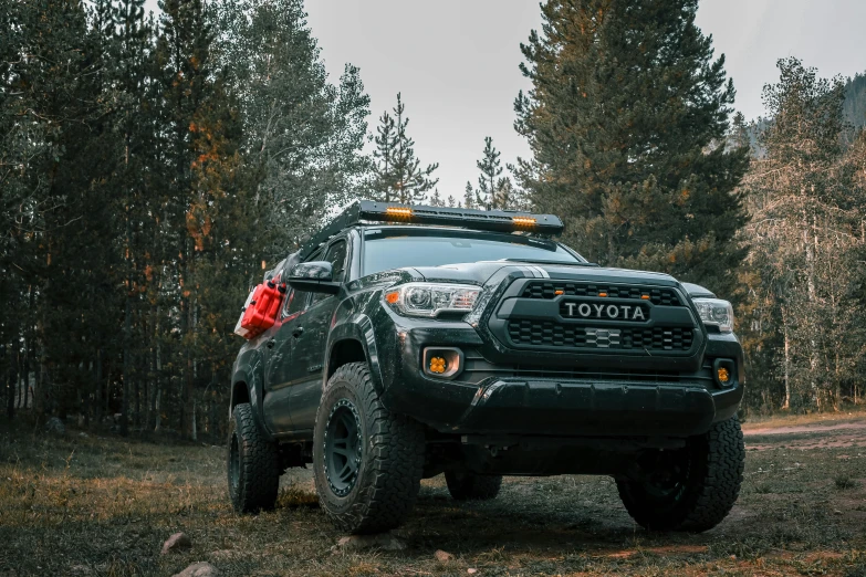 the large black truck has an orange light on the roof