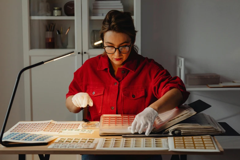 woman with eye glasses working on some type of tiles