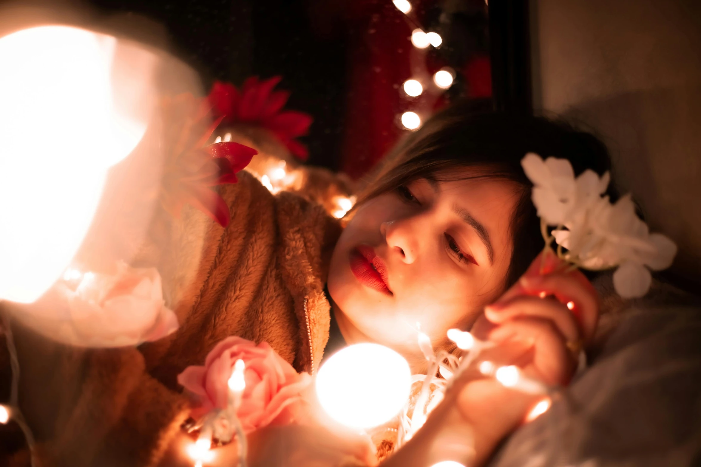 a woman who is holding two candles in her hand