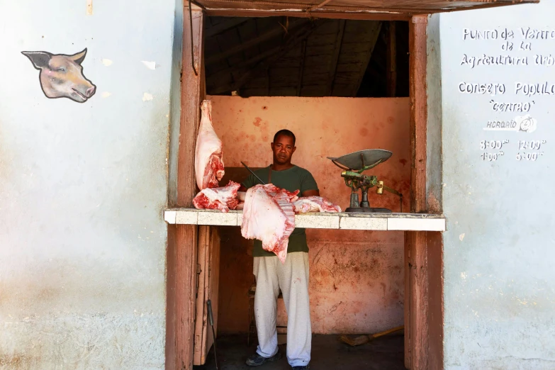 a man selling meat to a man in an open doorway