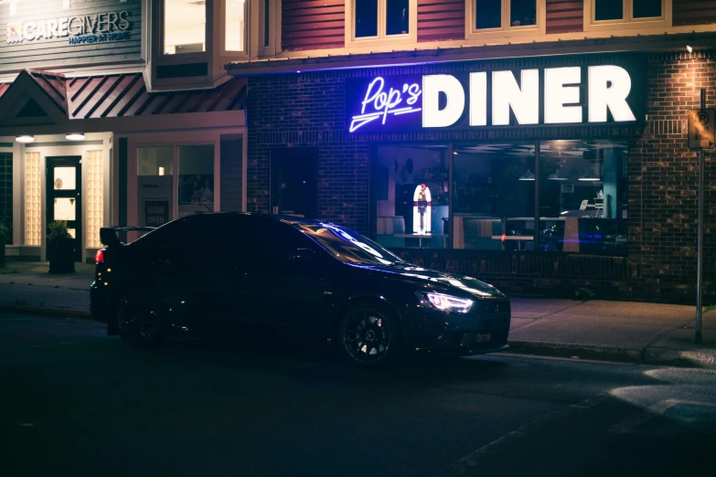 a parked car is sitting in front of a restaurant