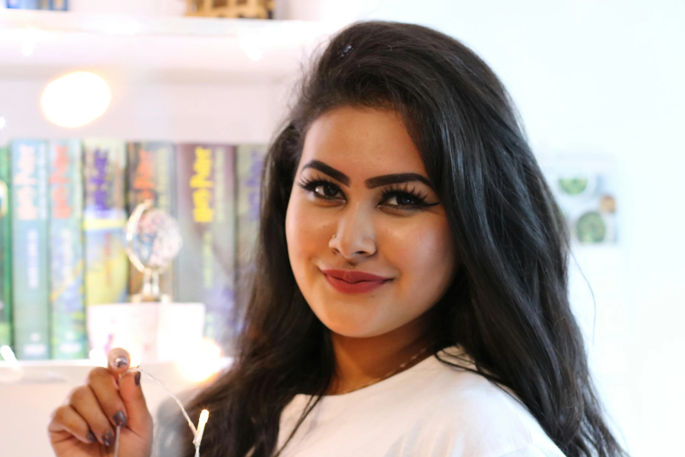 a woman that is holding a glass with some food