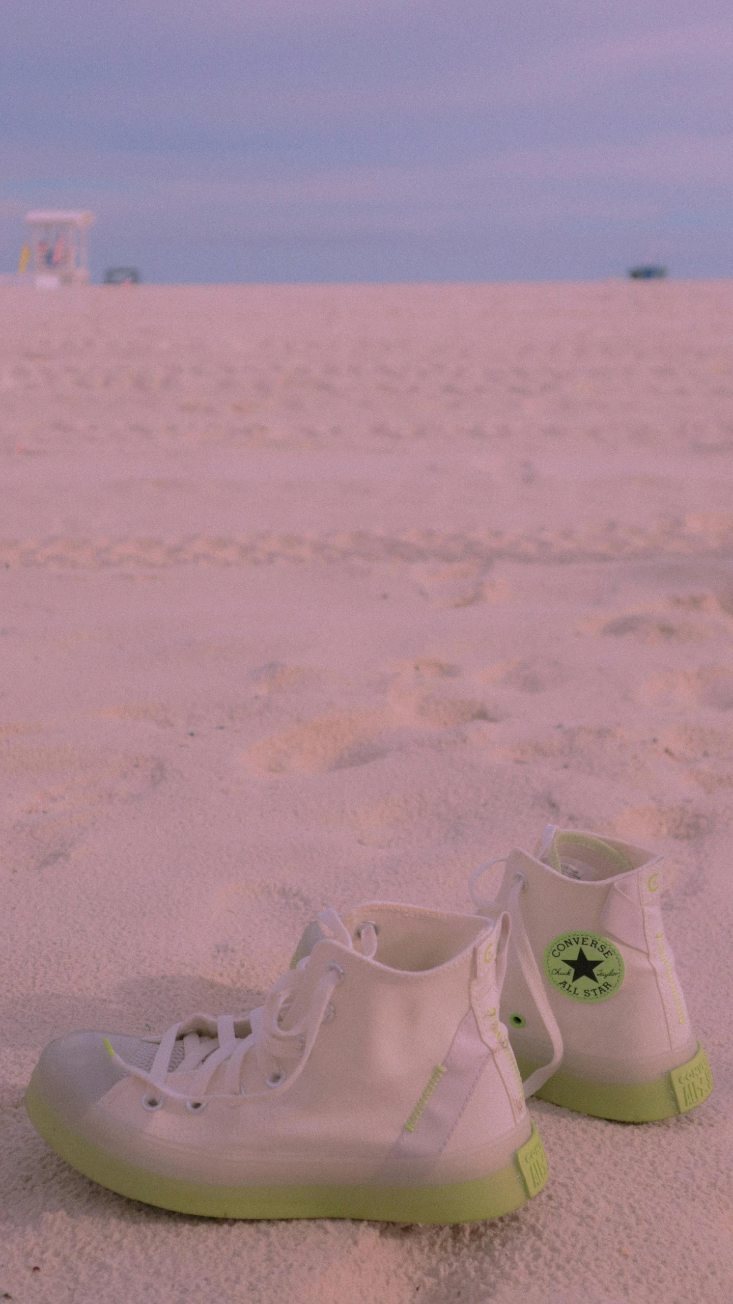 two shoes in the sand on the beach