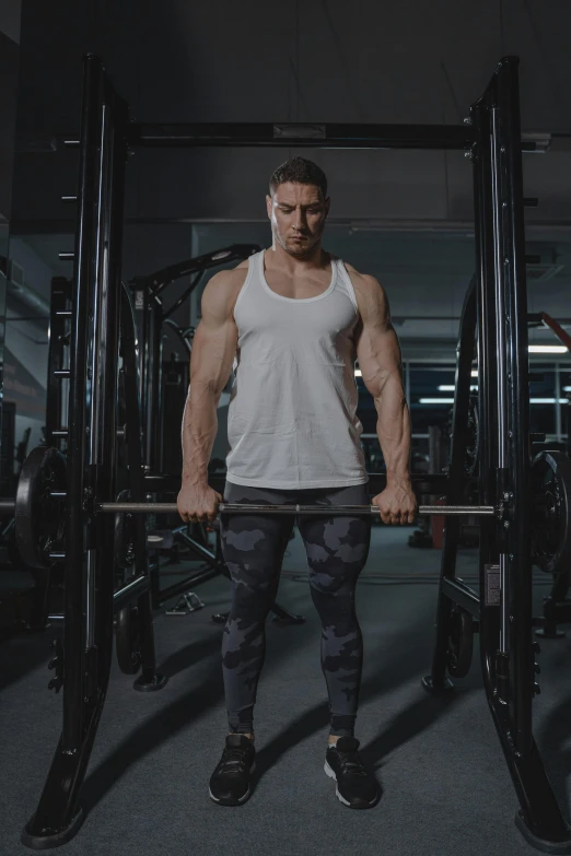 a man holding on to a barbell while working in the gym