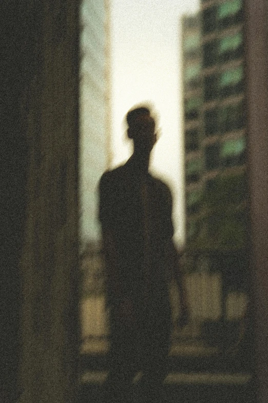 a silhouette of a person standing in the city