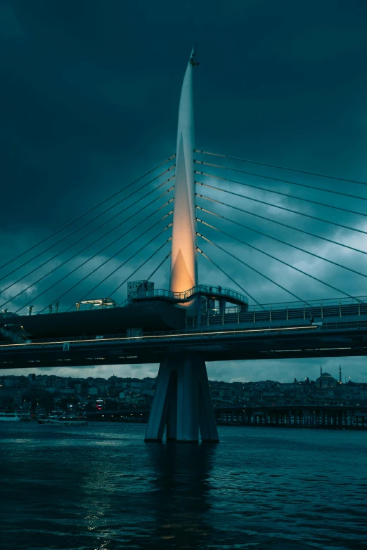 a very tall white bridge over water