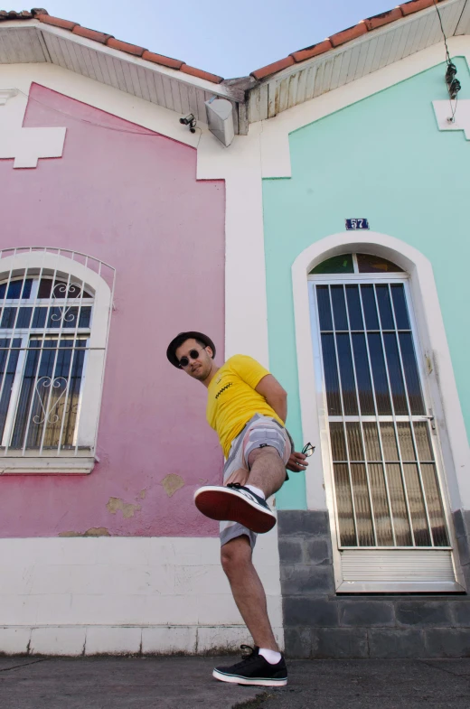 a man is in front of a building on his skateboard