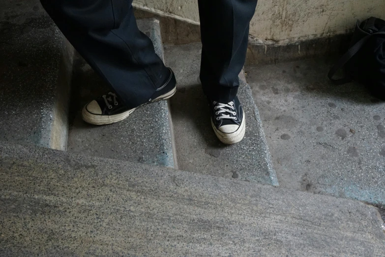 a person standing on a step with shoes