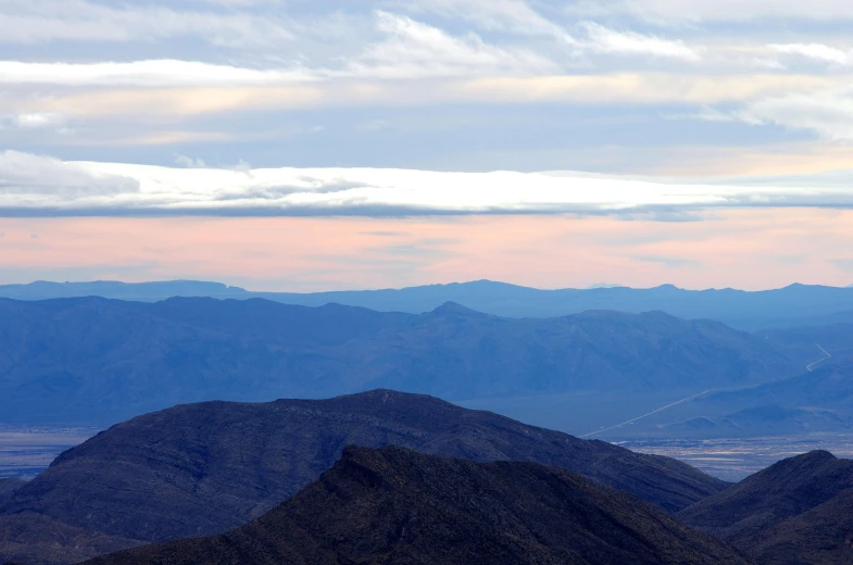 a scenic view of mountains with no traffic in the foreground