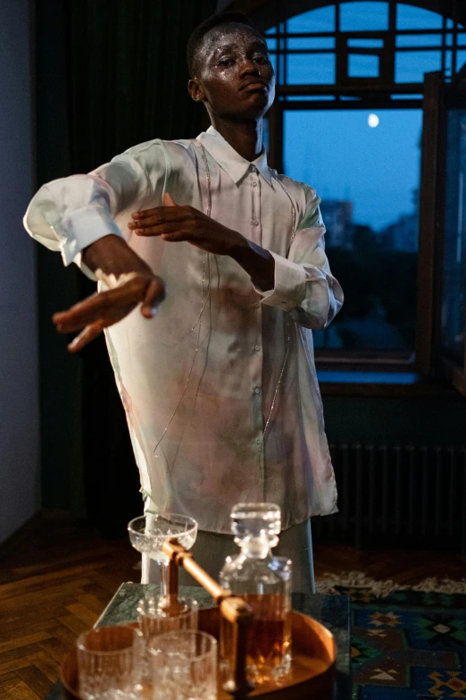 man in dress shirt and glasses standing in front of a window