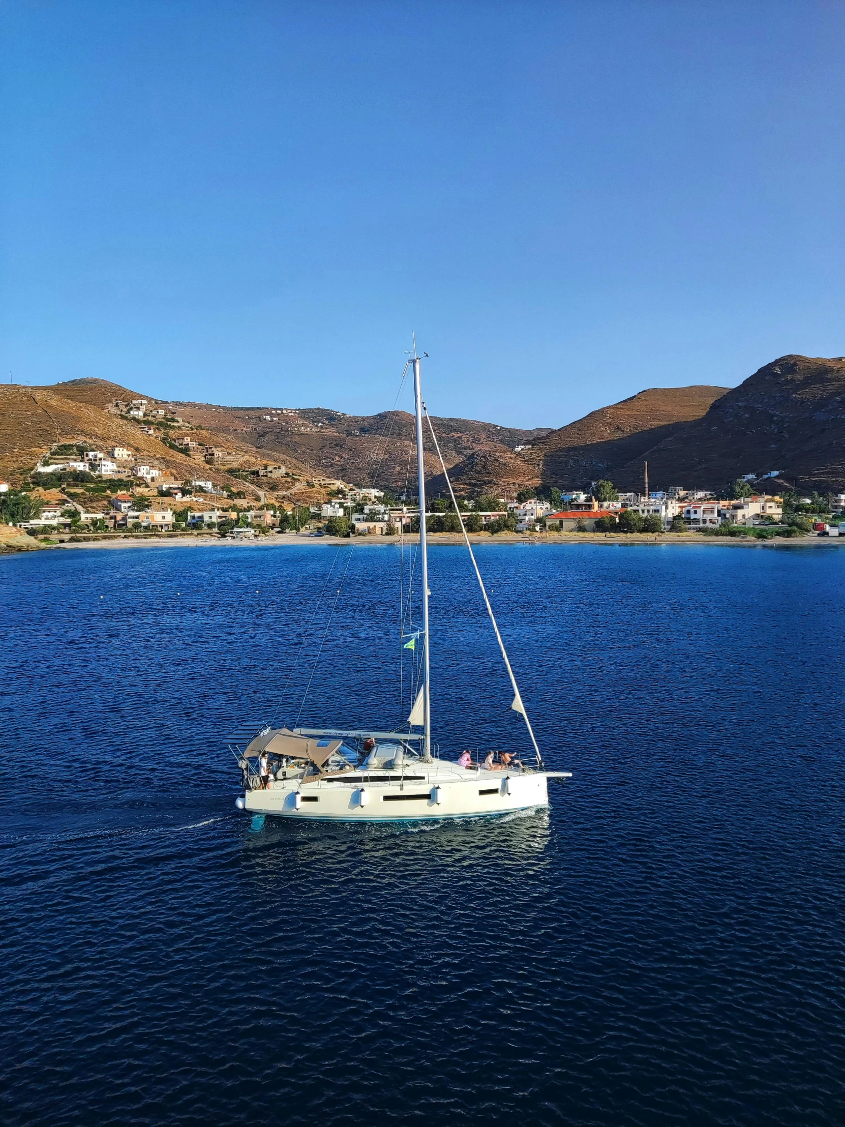 a small boat with a flag sailing across the water