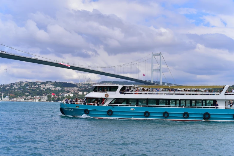 a boat is sailing in the ocean below a bridge