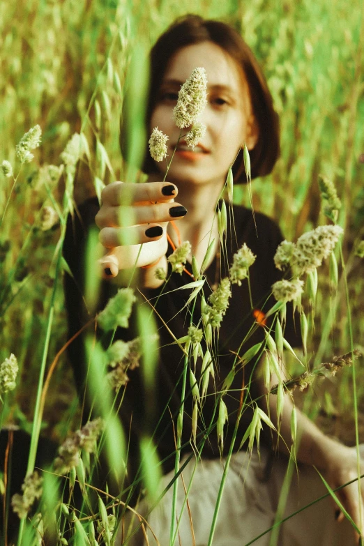 a woman holding a flower in her hand