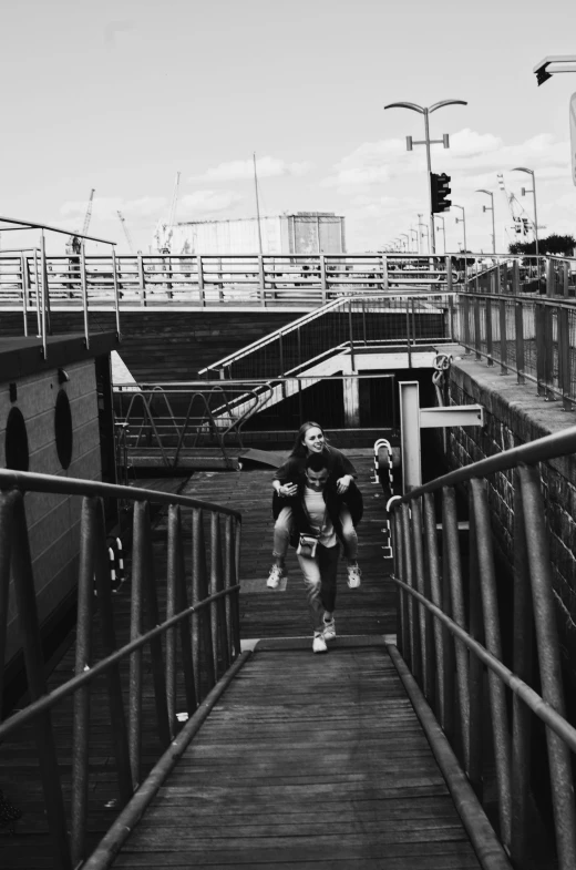 a man running down a flight of stairs carrying a skateboard