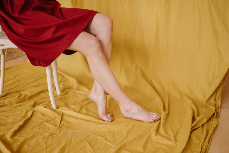 a woman's legs wrapped up in a red towel