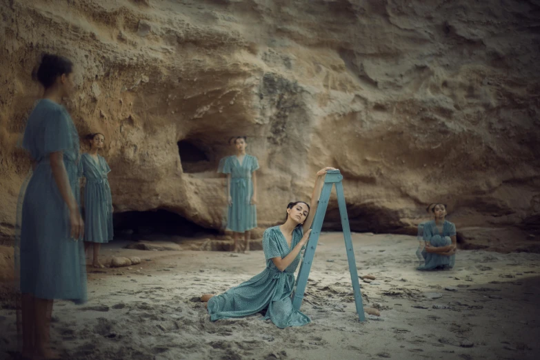 a woman in blue sits in front of statues