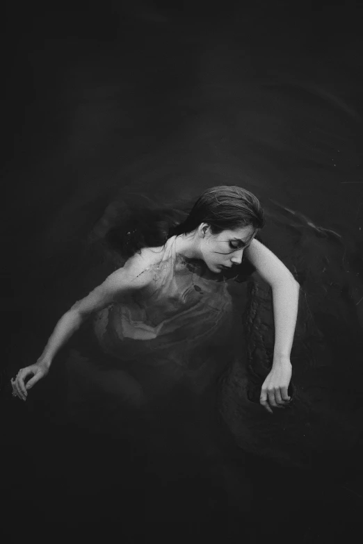 a woman is floating on the water by herself