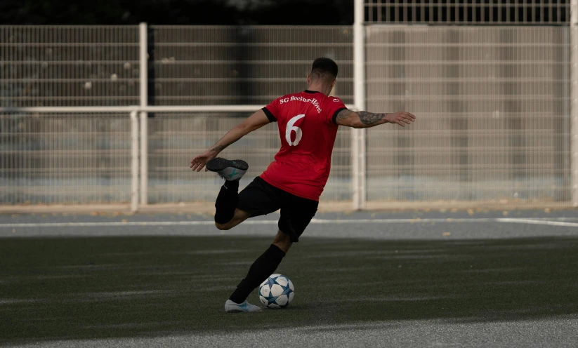 a soccer player is kicking a soccer ball