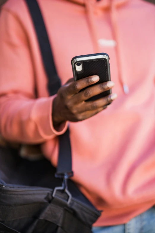 person with a camera is texting on their phone