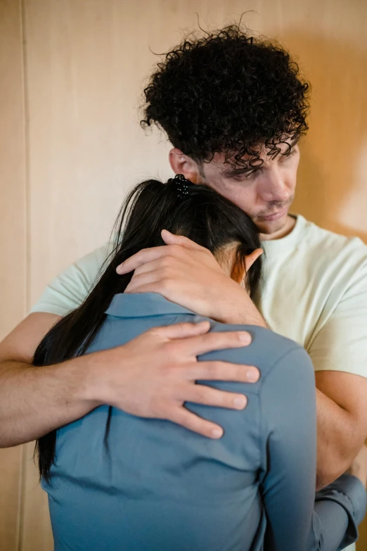 a man and a woman hugging each other