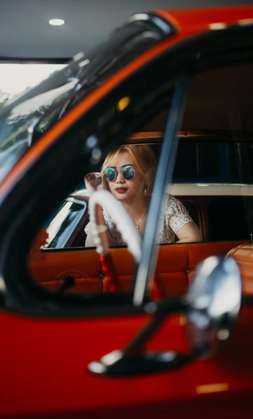 the girl is smiling while driving in her car