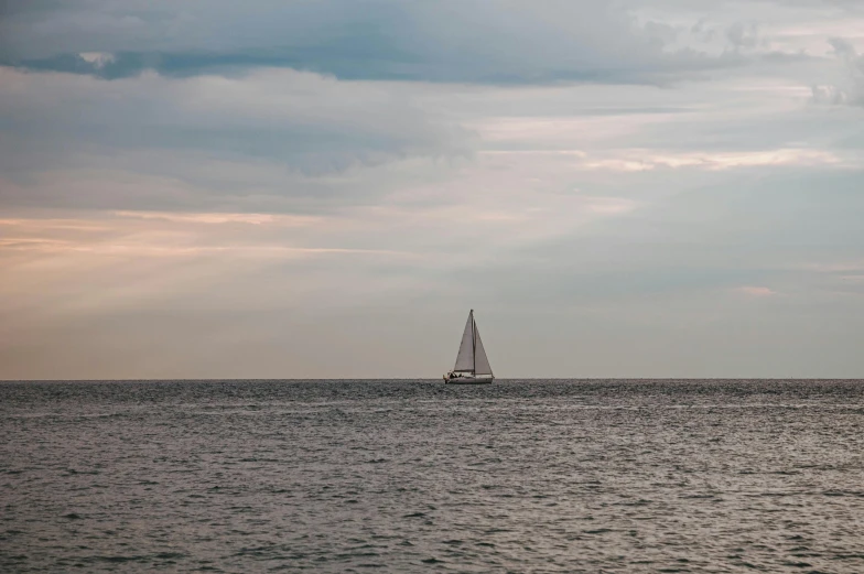 a sailboat that is sailing in the ocean