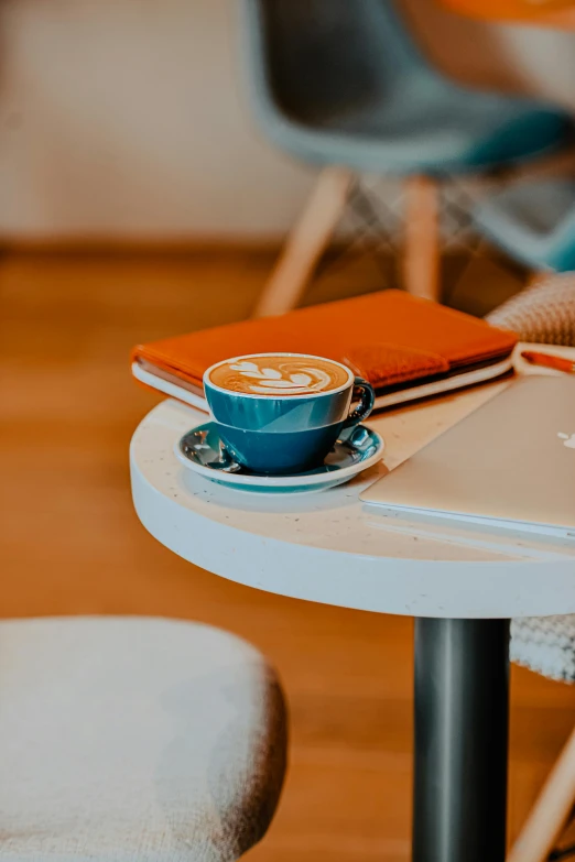 the tabletop is covered with a cup of coffee on the table