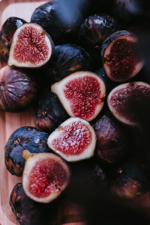 some figs on a board in a wooden box