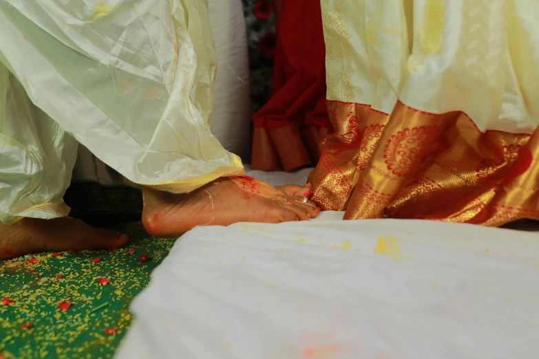 woman with gold jewelry is putting gold on her leg