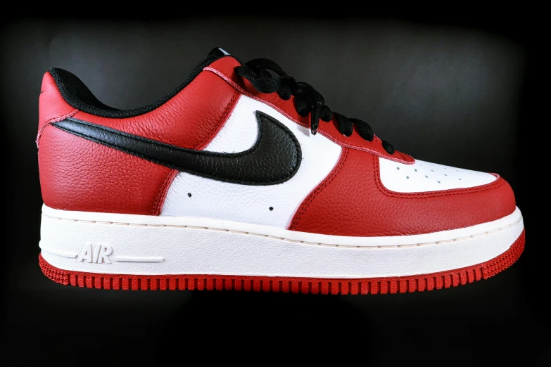 a shoe that is red and white with a black top