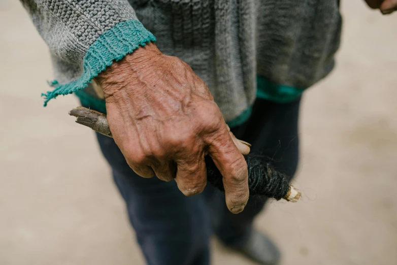 a person holding an animal's head, while wearing it in one hand