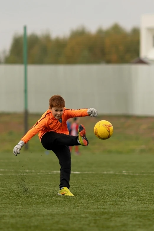 a  is kicking a soccer ball while playing