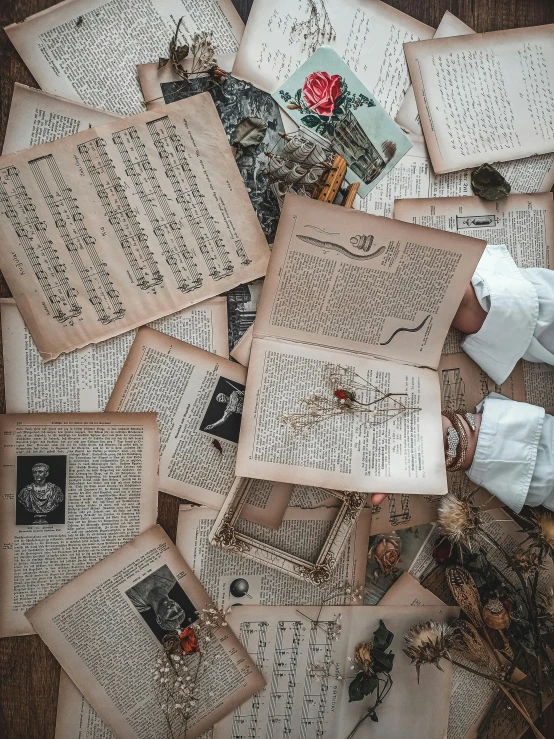 vintage books on the ground covered in pages